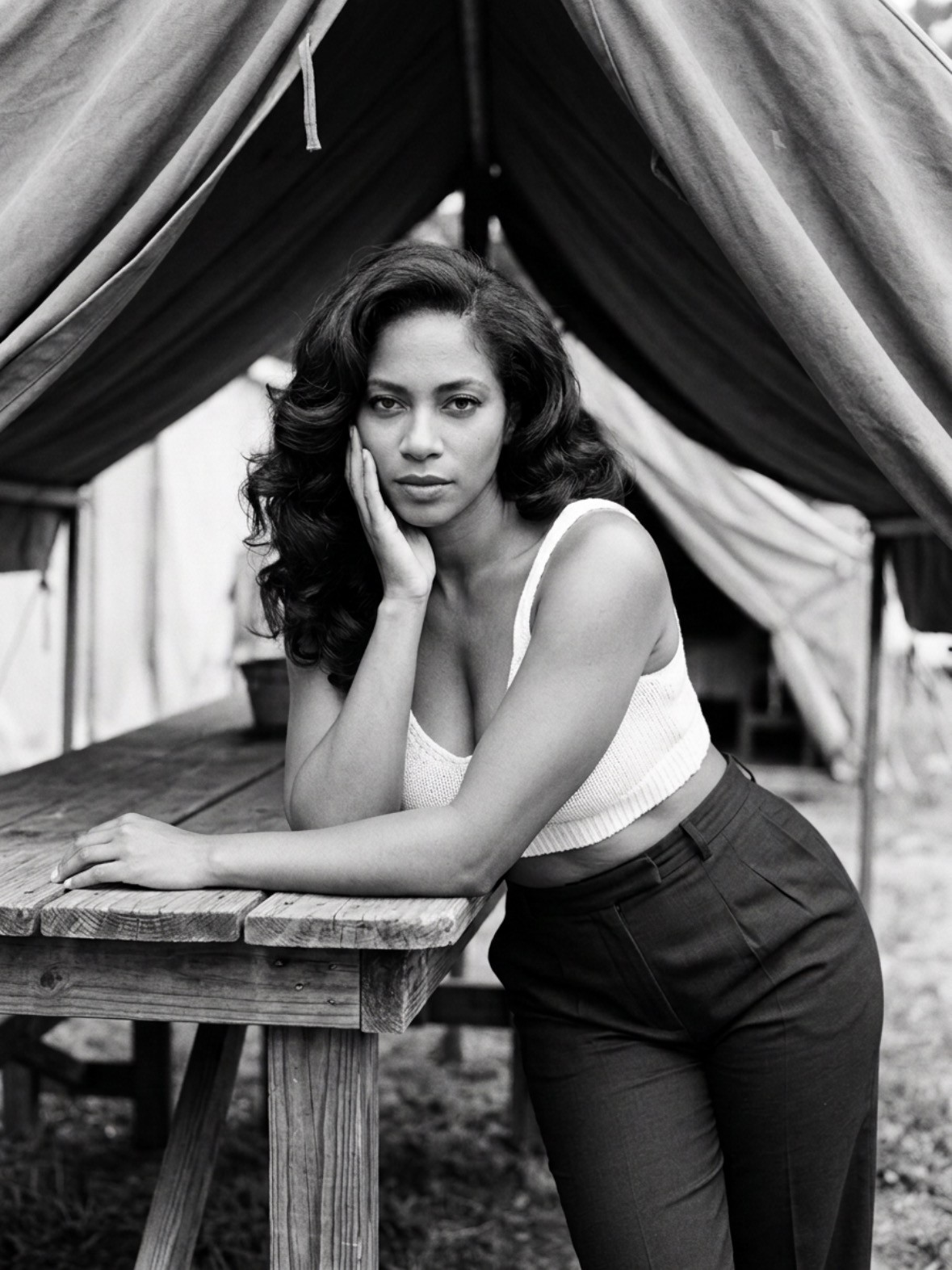 Warm-toned monochrome portrait of Nichasie Miller seated at a wooden table